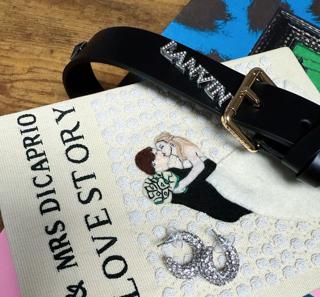 luxury gifts including a Lanvin belt, crystal encrusted hoop earrings, and Olympia Le-Tan book